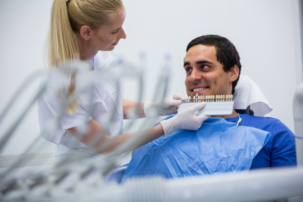 Dental patient discussing affordable dental implant payment options and insurance coverage with a dentist in the Bronx.