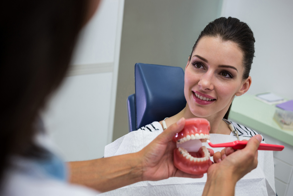 Patient smiling confidently after receiving dental implants that restore natural appearance, chewing function, and jawbone health.